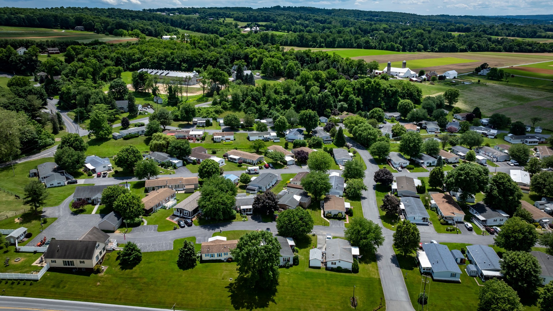 Overview of Mobile, Prefab, Manufactured Home Rural Neighborhood Surrounded Green Fields Open Skies